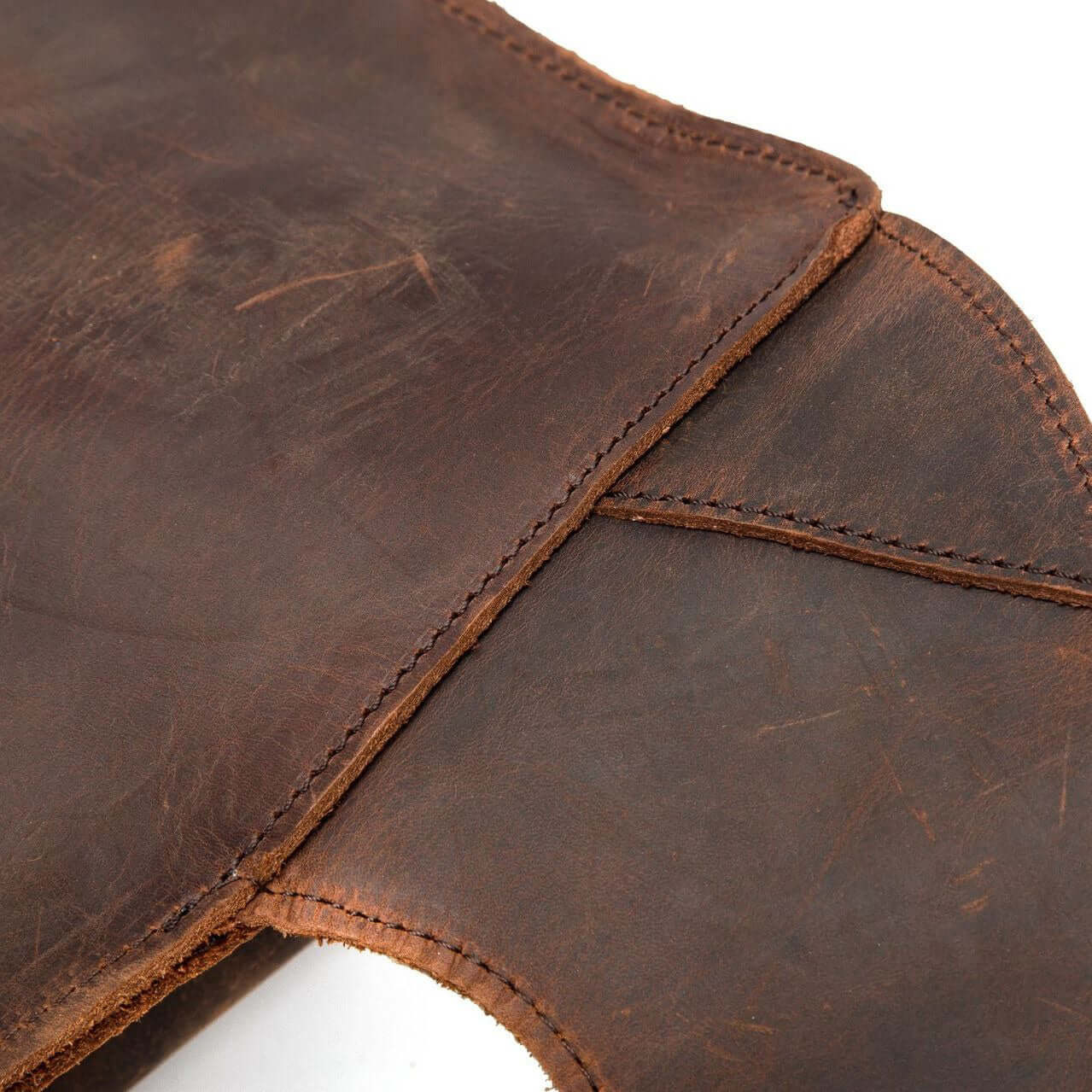 Close-up of vintage genuine leather, showcasing rich texture and stitching details, ideal for a stylish backpack.