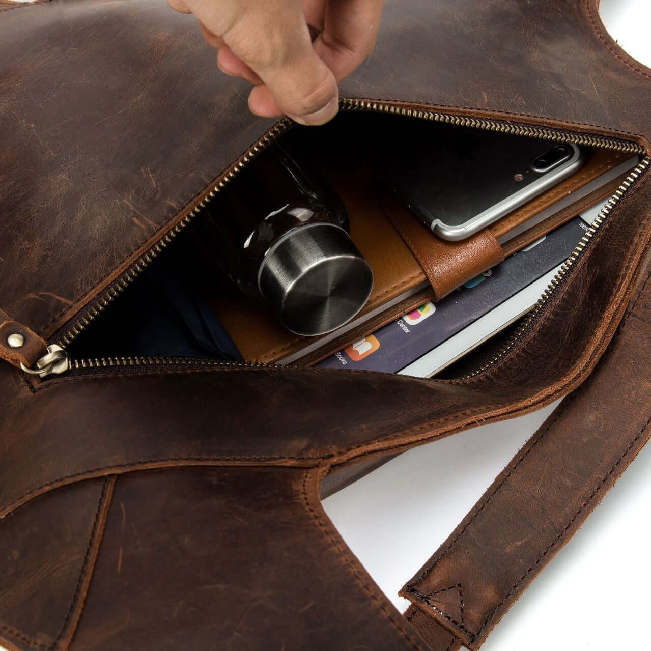 Inside view of a natural leather backpack showcasing organized compartments for travel essentials.