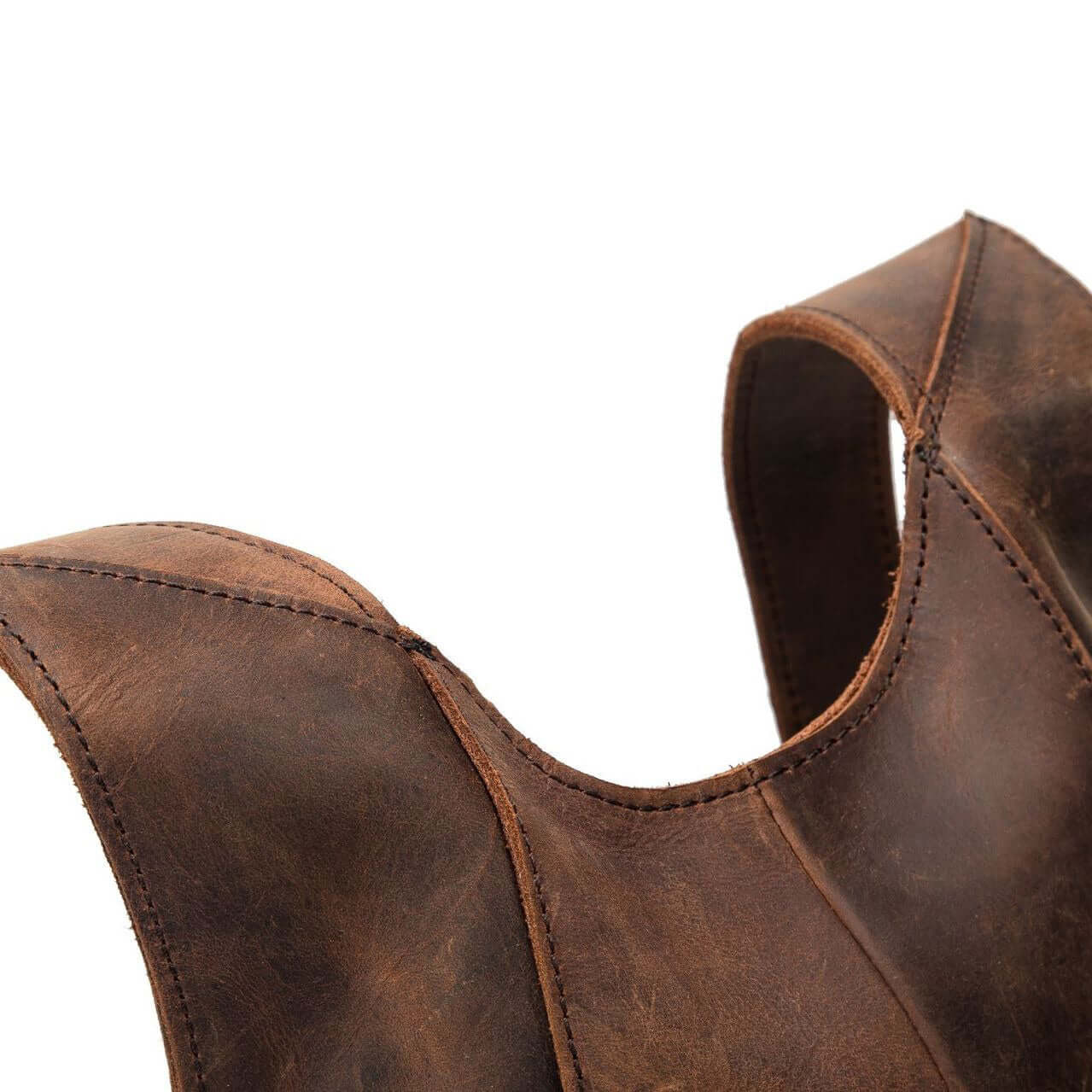 Close-up of the vintage natural leather backpack straps, showcasing the sturdy stitching and rich brown color.