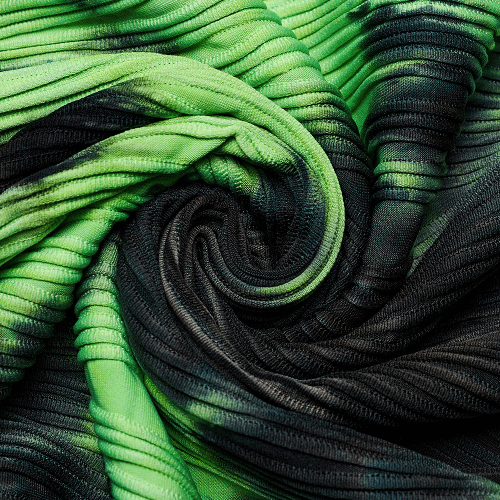 Close-up of neon green and black tie-dye fabric with a textured spiral design, perfect for edgy fashion statements.