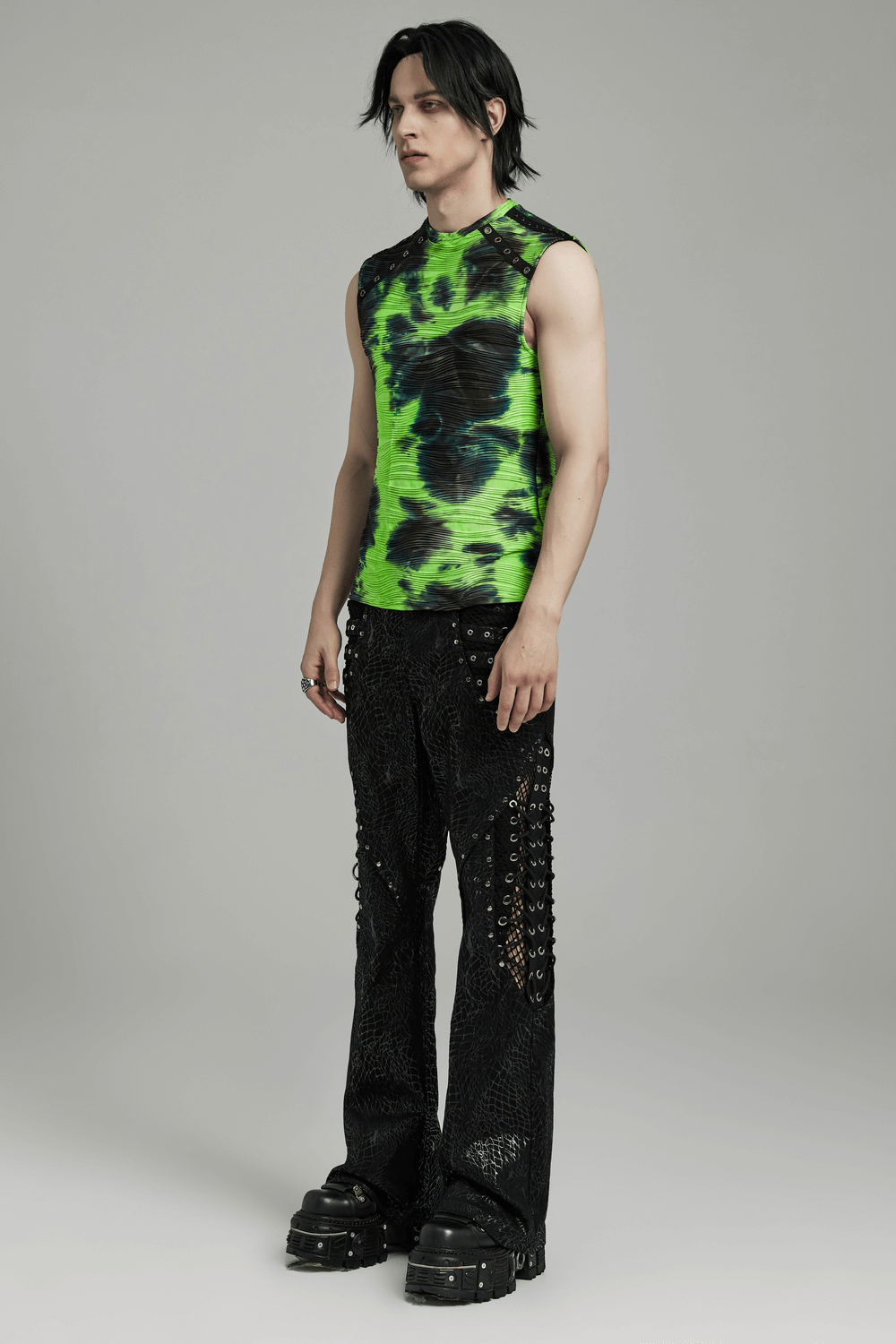 Neon green tie dye sleeveless tank top with rivet details, paired with edgy black pants, perfect for alternative street style.