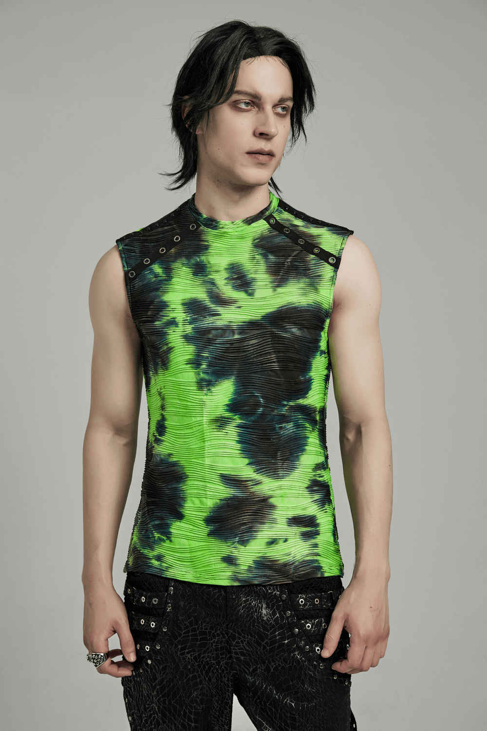 Neon green tie dye sleeveless tank top with rivet details, showcased by a model for alternative street style fashion.