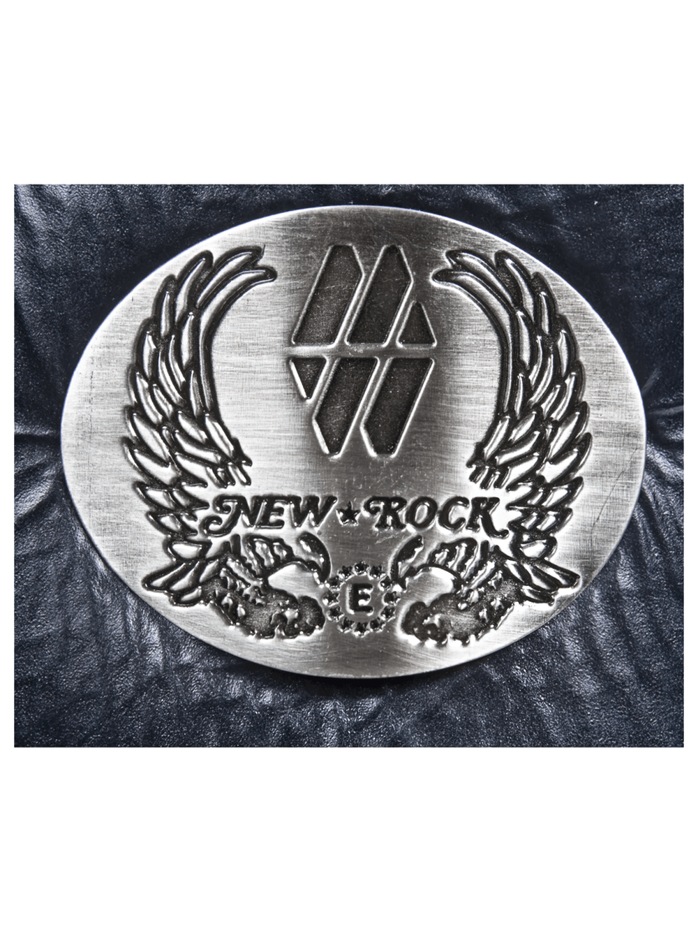 New Rock logo badge with eagle wings design on black leather background, adding a punk rock touch.