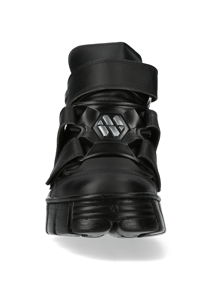 Chunky black velcro ankle boots with urban rock style, featuring a bold design and durable sole.