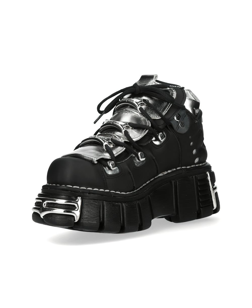 Stylish black punk ankle boots with metallic accents and chunky soles, perfect for a bold rock-inspired look.