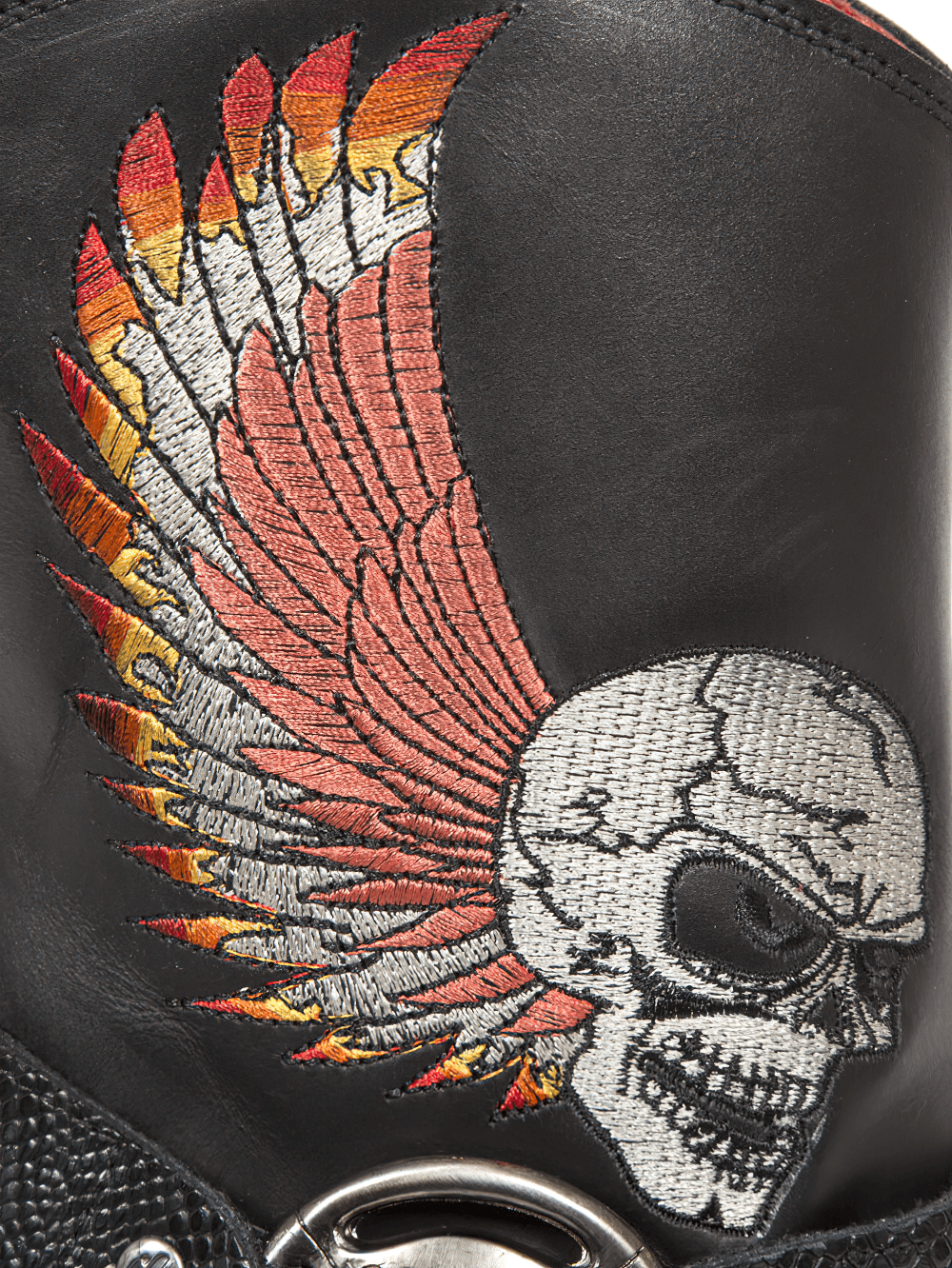 Close-up of NEW ROCK ankle boot showcasing vibrant skull and wing embroidery on black leather.