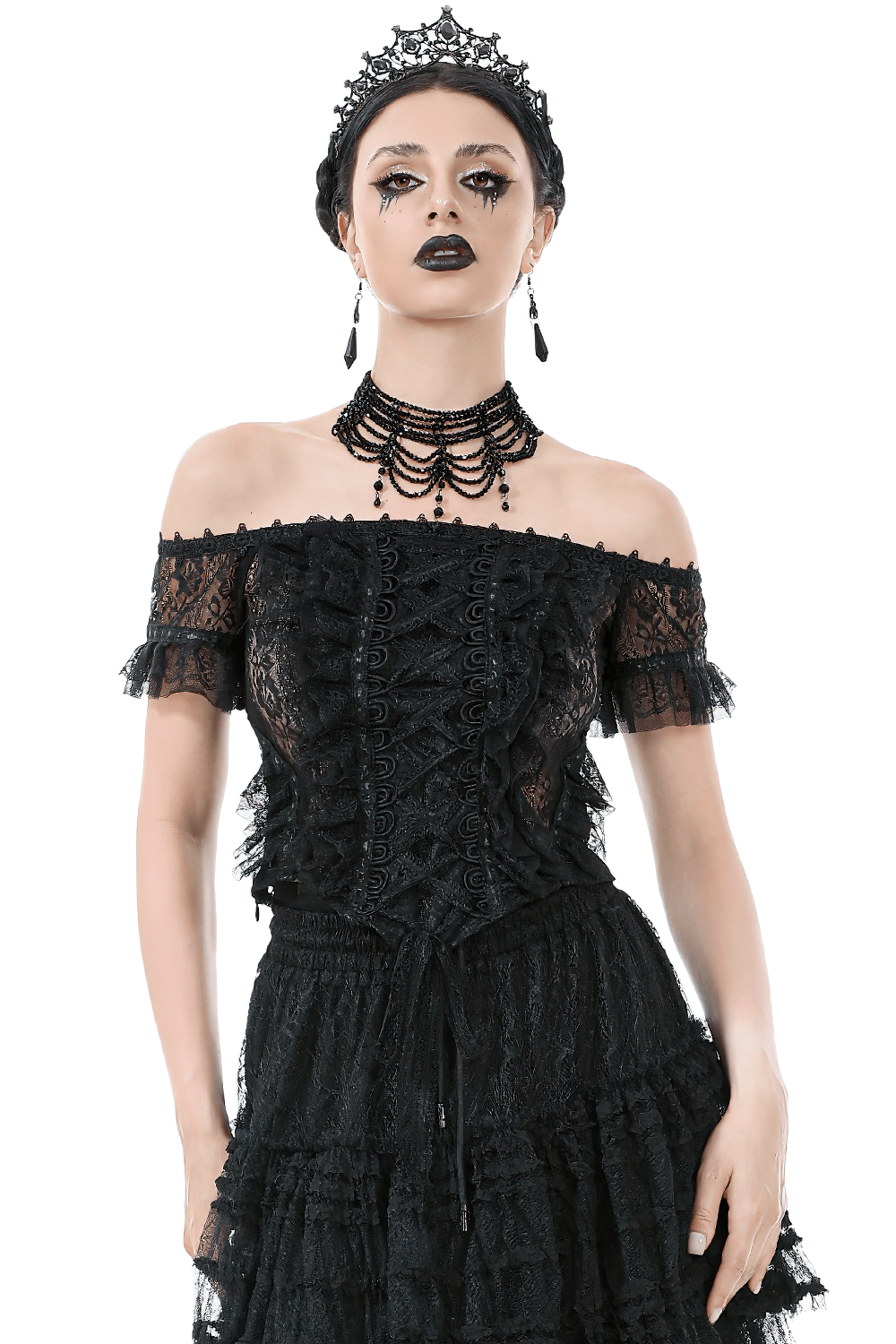Off-shoulder lace-trimmed gothic top with ribbon details, styled with dramatic accessories for a bold look.