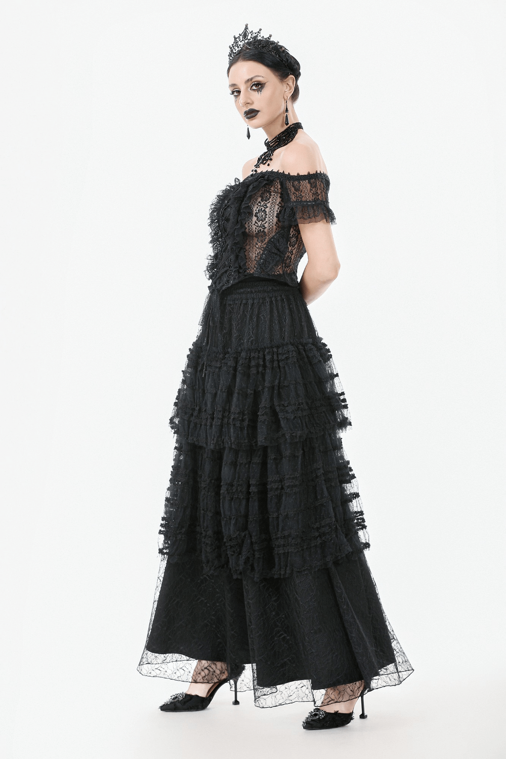 Off-shoulder lace-trimmed gothic top with ribbon details, paired with a layered black skirt, showcasing dramatic elegance.