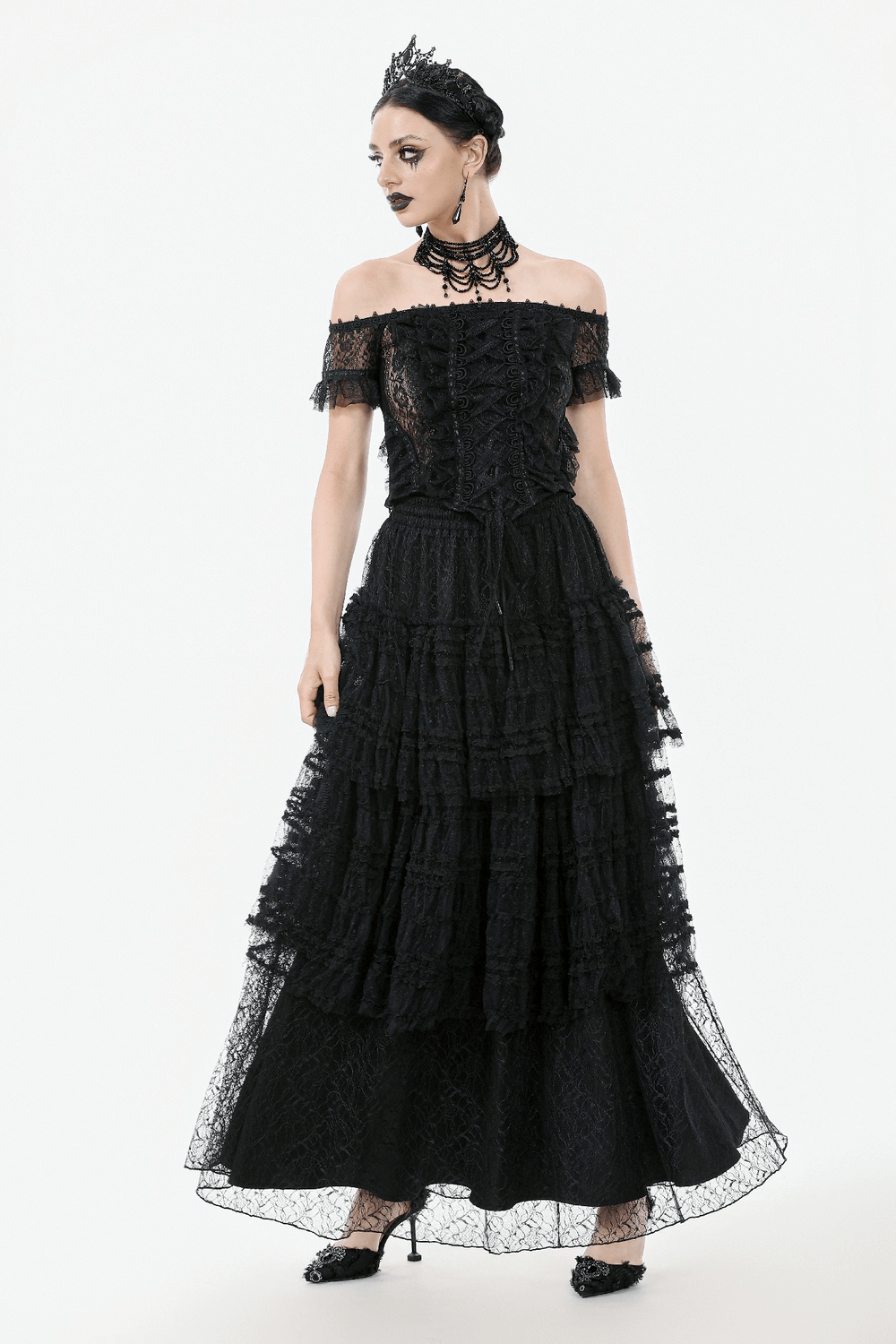 Off-shoulder lace-trimmed gothic top with ribbon details, paired with a layered black skirt for a dramatic look.