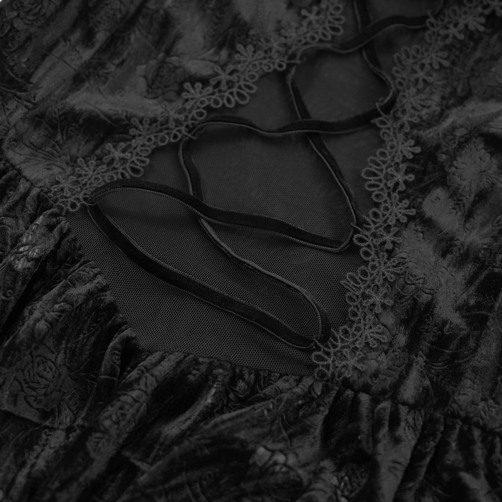 Close-up of black velvet top featuring intricate lace-up detailing and sheer mesh fabric for a gothic-inspired look.
