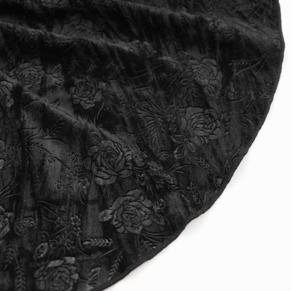 Close-up of black velvet fabric with floral pattern, showcasing luxurious texture and gothic elegance.