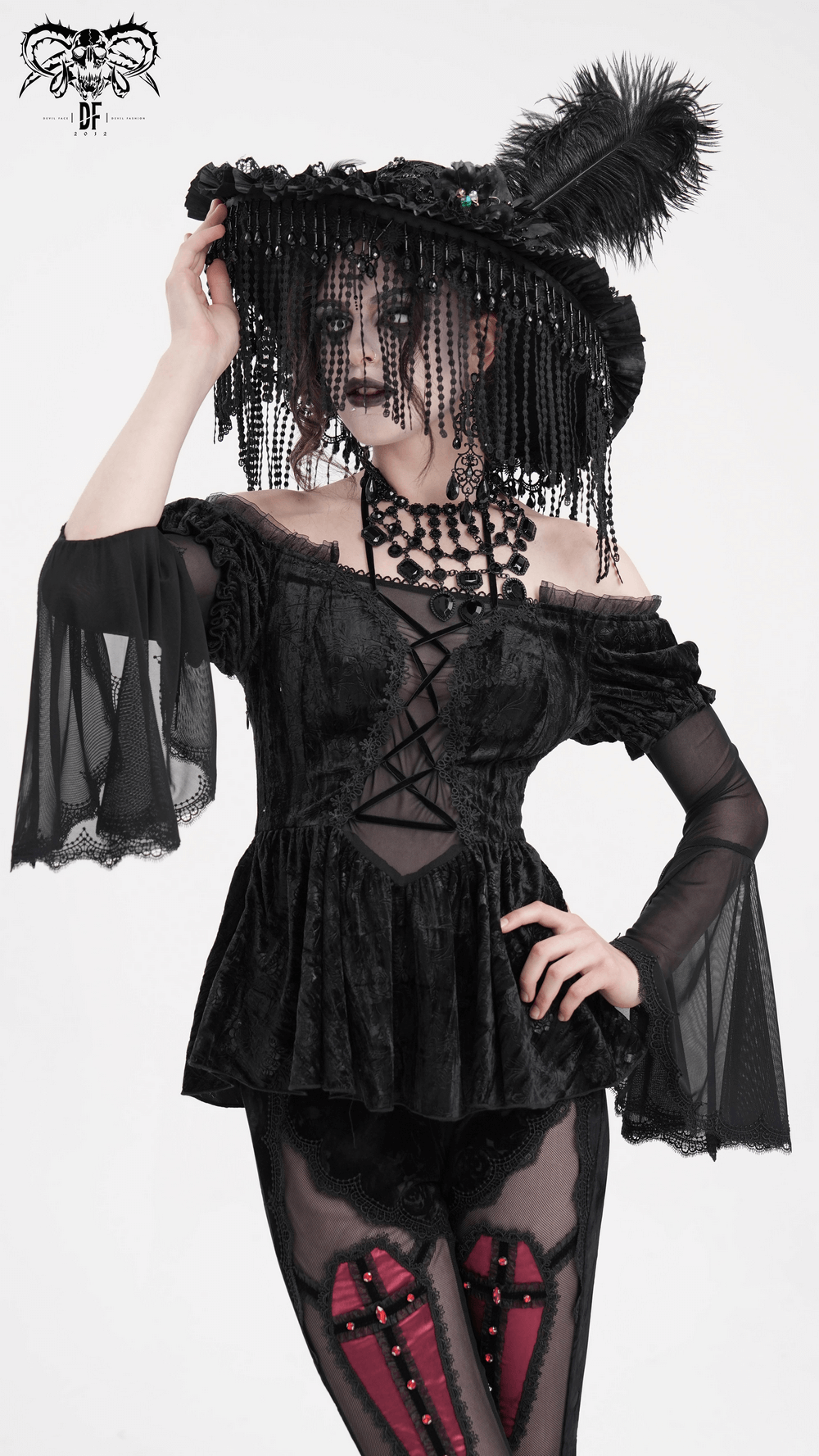 Gothic elegance: Off-shoulder velvet top with sheer sleeves and lace detailing, perfect for dark romantic fashion.