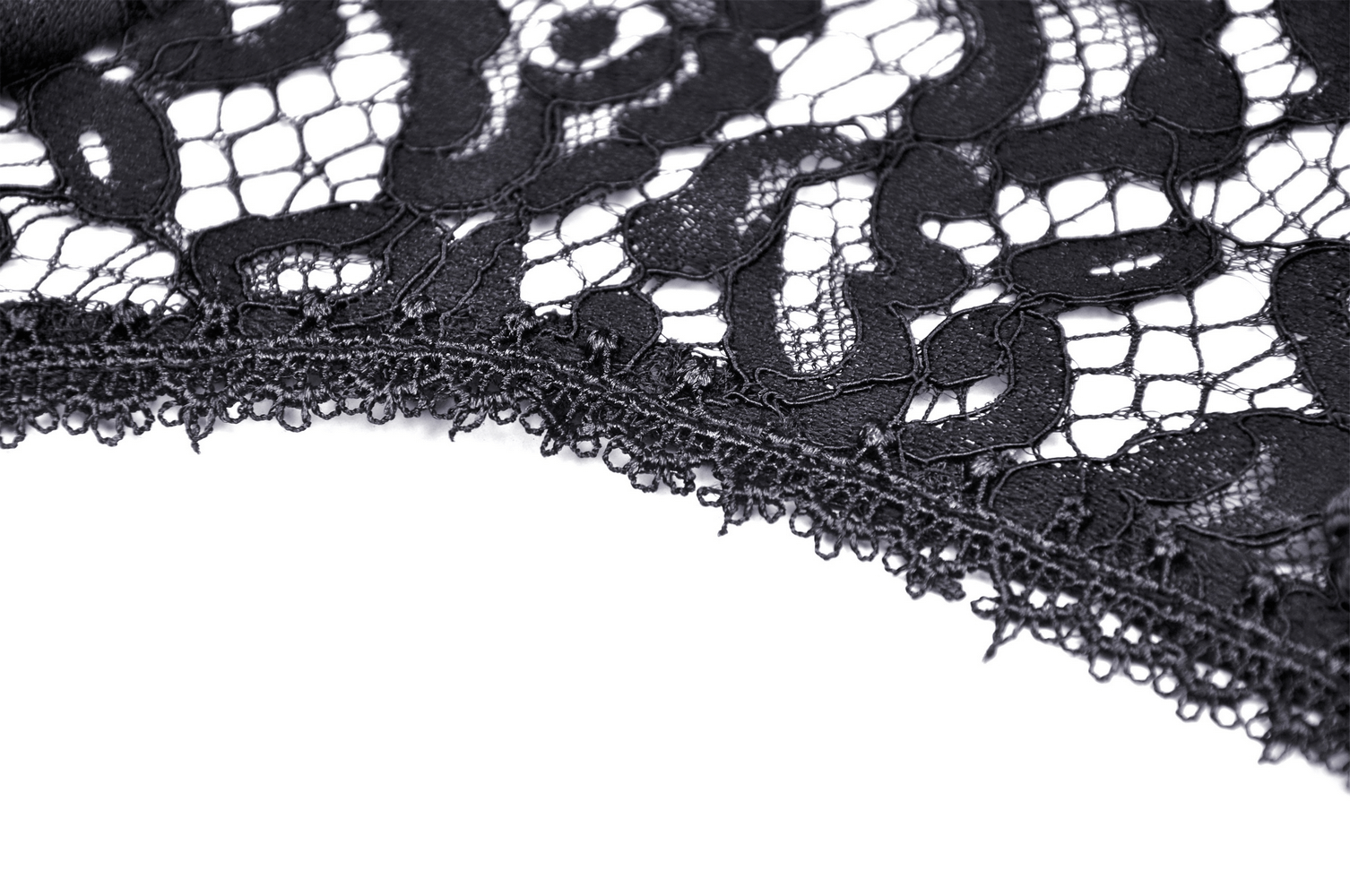 Close-up of intricate black lace fabric, showcasing vintage elegance and delicate patterns.