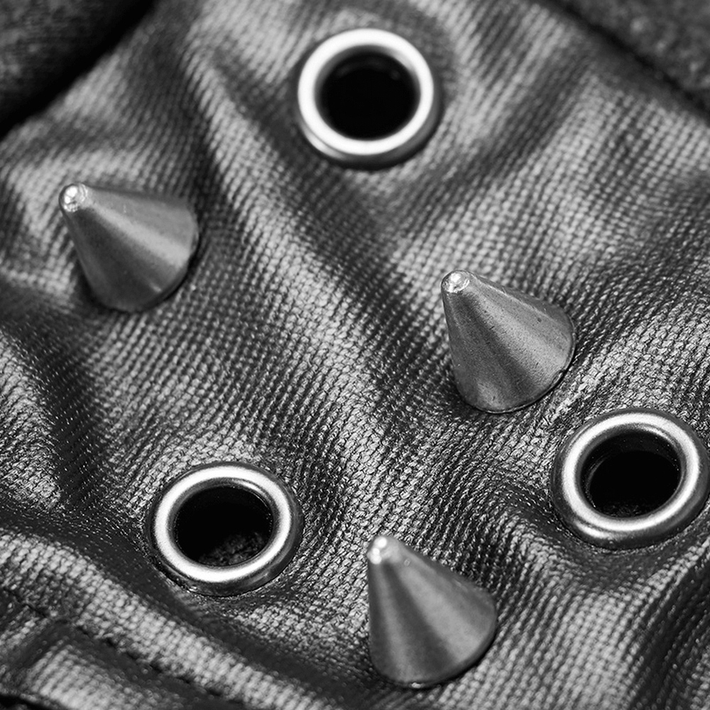 Close-up of punk jacket detailing with silver studs and grommets on faux leather fabric.