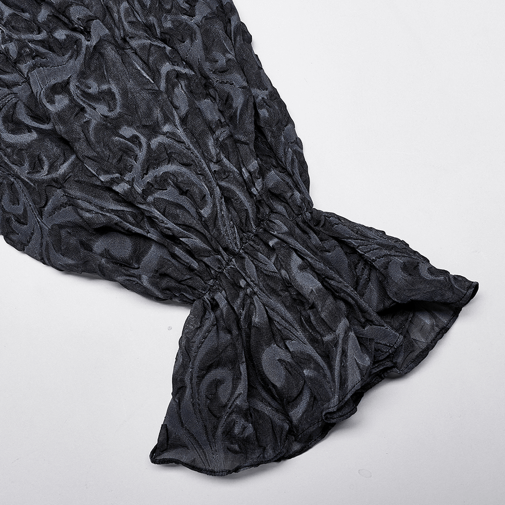 Close-up of gothic embossed shirt sleeve showcasing intricate patterns and texture in dark chiffon fabric.