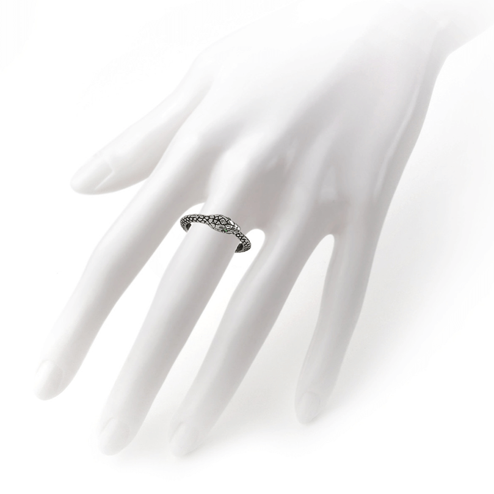 Ouroboros Sophia Serpent ring on a hand showcasing green Austrian crystal eyes for a mystical touch.