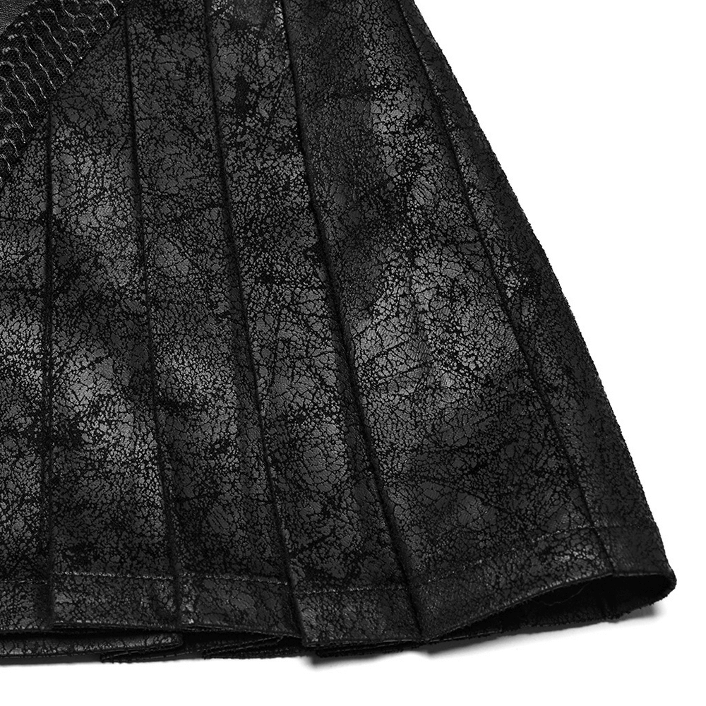 Close-up of black pleated leather skirt featuring cracked texture and bold zipper details, perfect for an edgy look.