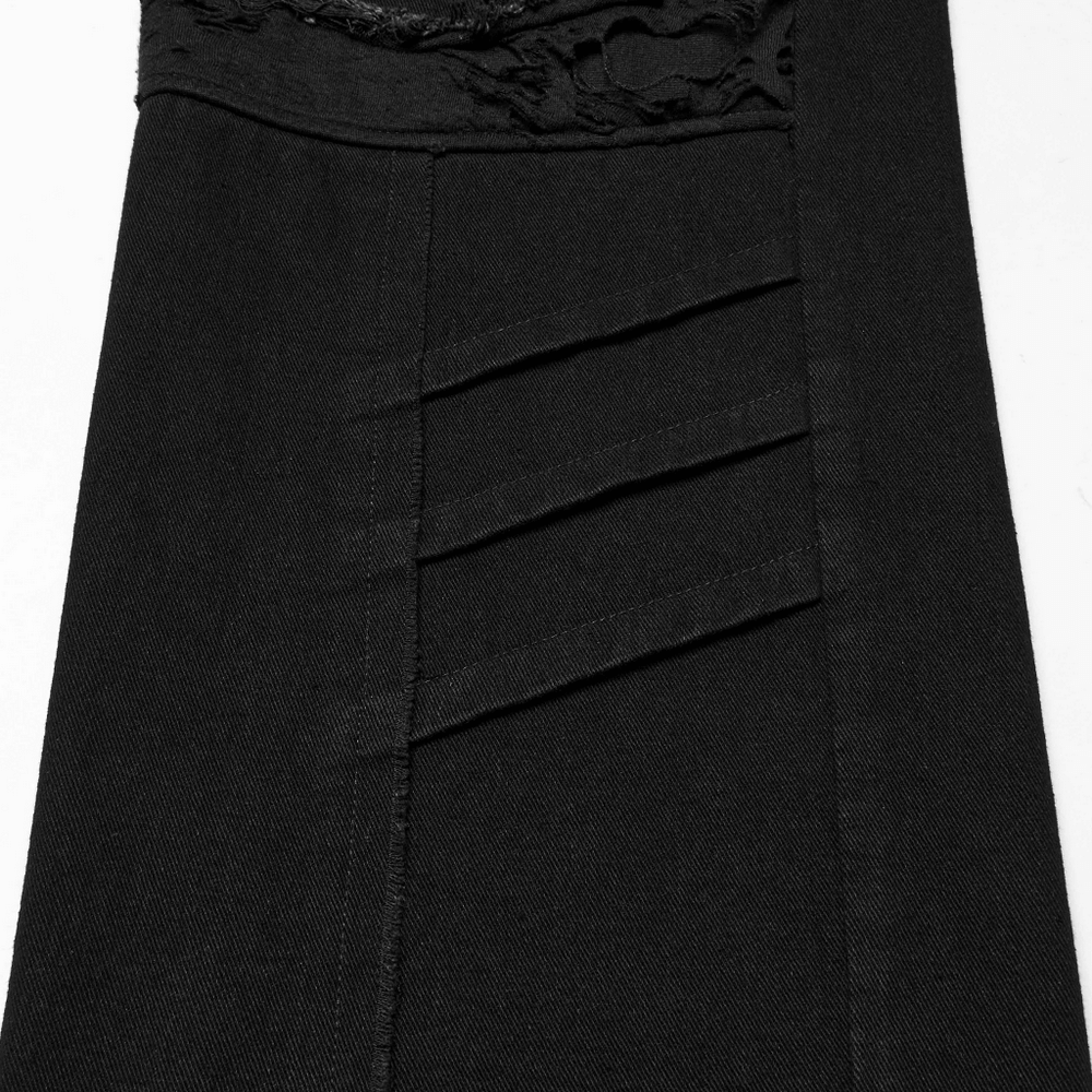 Close-up of black punk pants featuring ripped detail and layered textures, perfect for an edgy style.