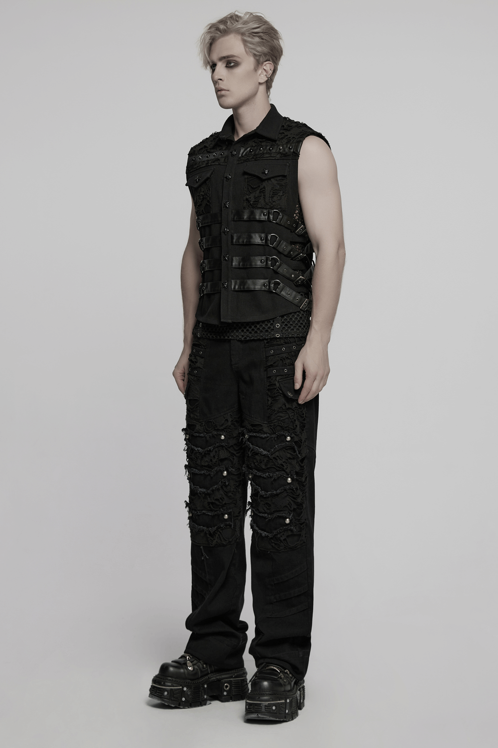 Model showcasing black personalized punk pants with tassels and ripped details, paired with a sleeveless vest.