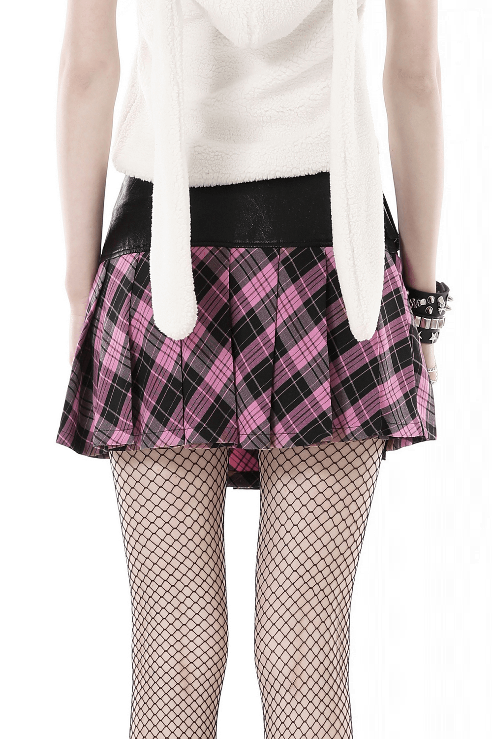 Back view of pink and black plaid mini skirt with edgy leather belt and fishnet stockings, showcasing punk rock style.