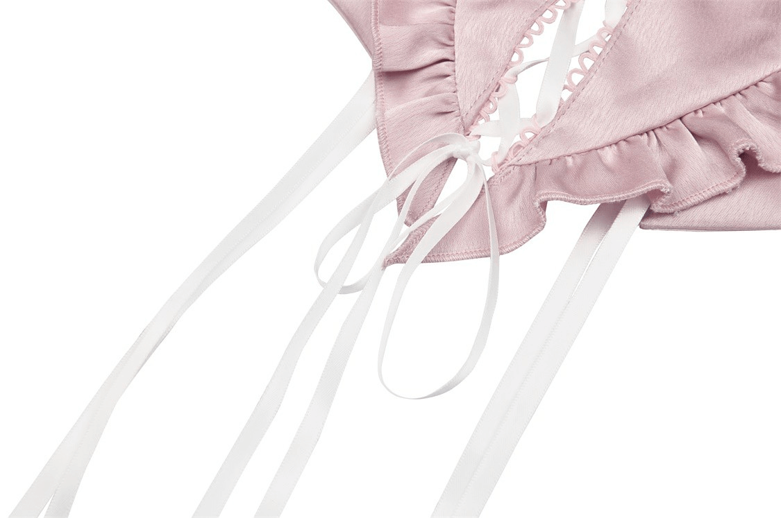 Close-up of pink heart-shaped bustier top with lace-up front and white webbing detail.
