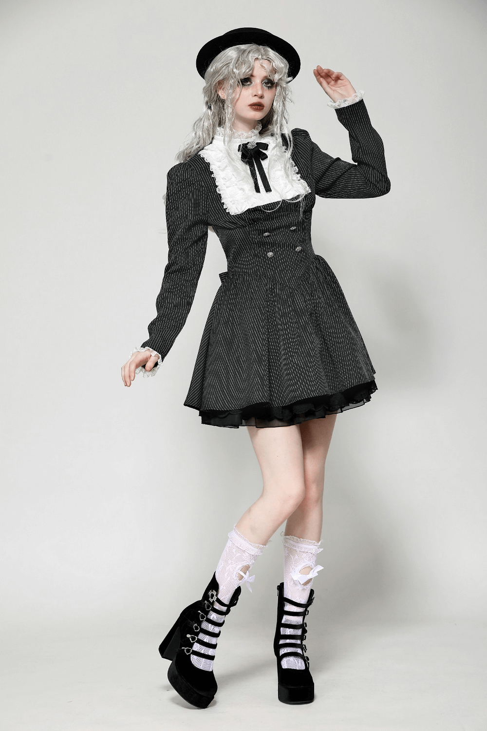 Stylish model in pinstripe gothic dress with lace ruffle and bow, showcasing vintage charm and alternative fashion.