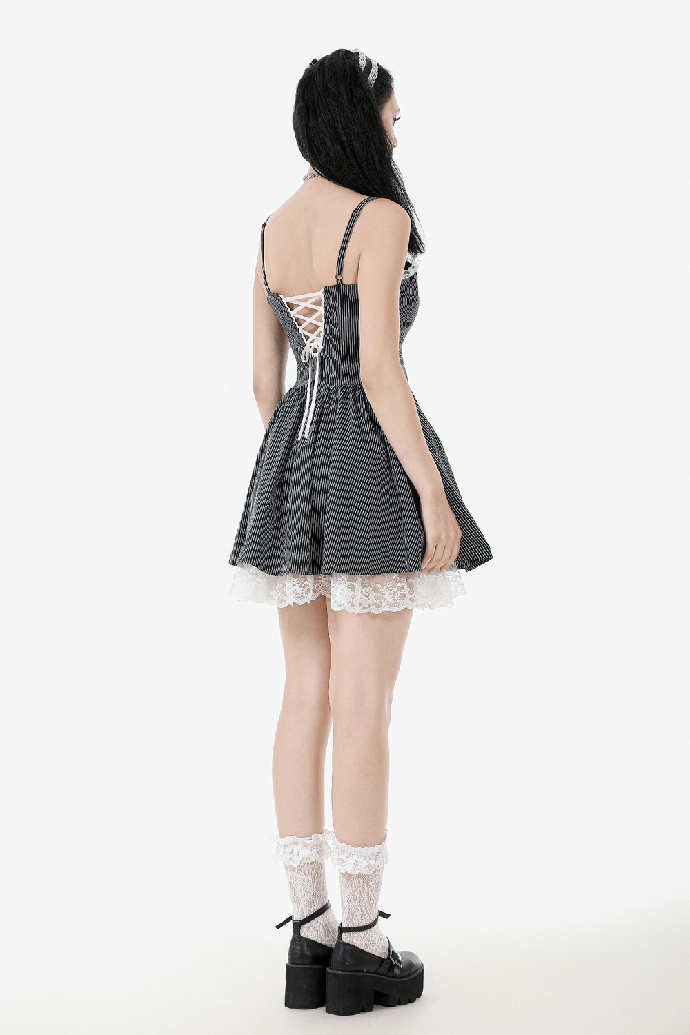 Back view of a vintage-inspired pinstripe Gothic dress with lace trim and corset back, showcasing ruffled hem and adjustable straps.