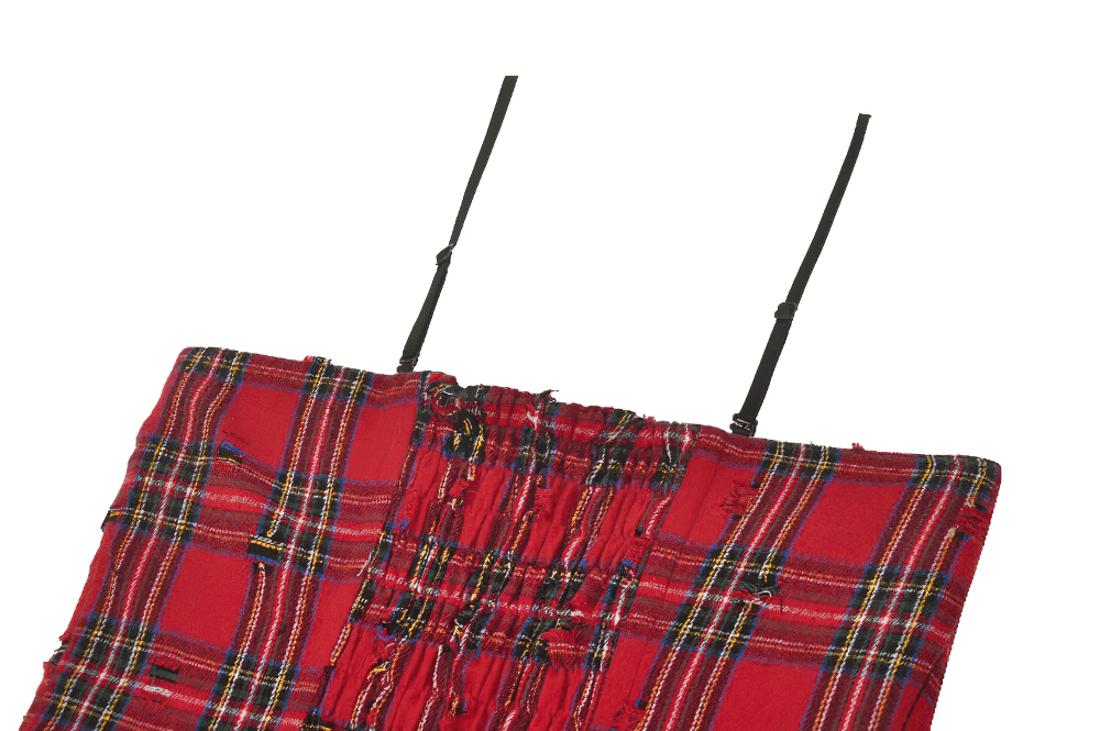 Close-up of red plaid corset dress with edgy black straps and smocked detailing, perfect for punk-inspired fashion.