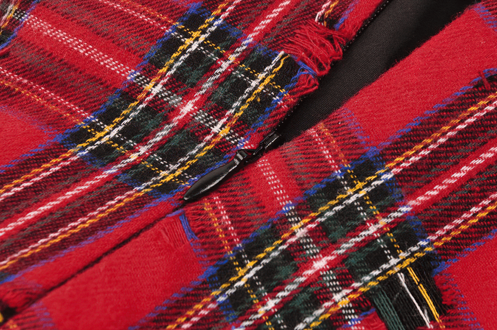 Close-up of red plaid fabric with bold patterns and textures, highlighting the edgy design of a punk-inspired dress.