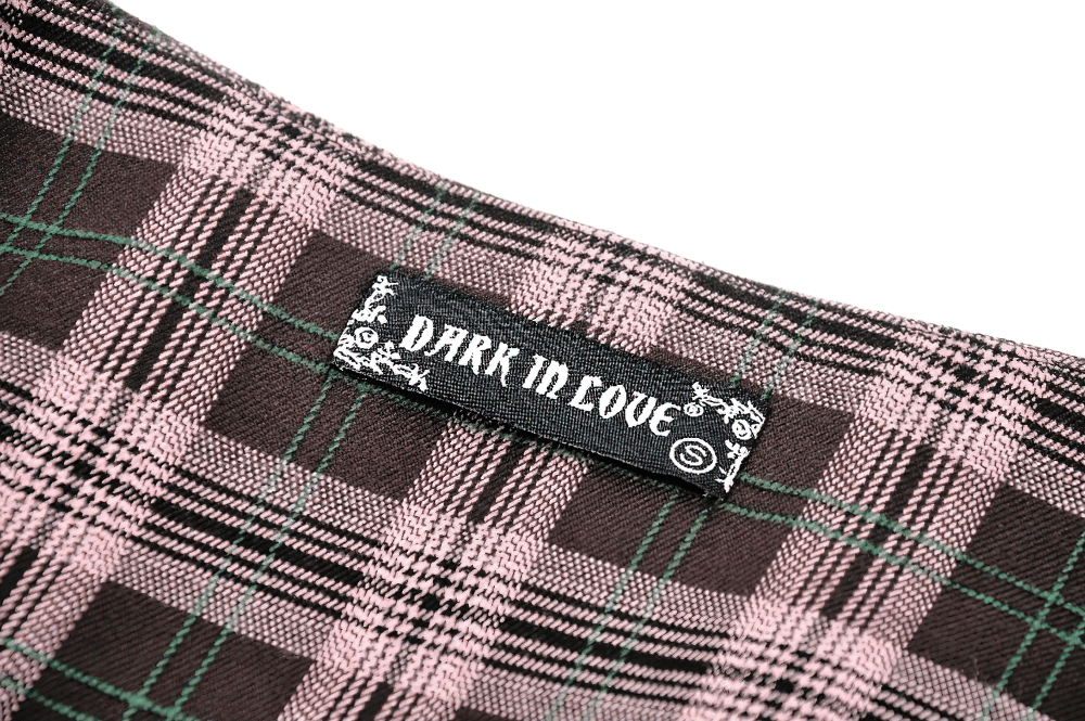 Dark in Love brand label on plaid fabric showcasing trendy pink and black pattern with green accents.