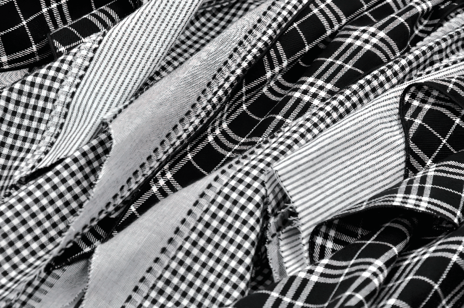 Plaid Skirt with Ruffled Design and Adjustable Belts fabric details featuring various black and white plaid patterns.