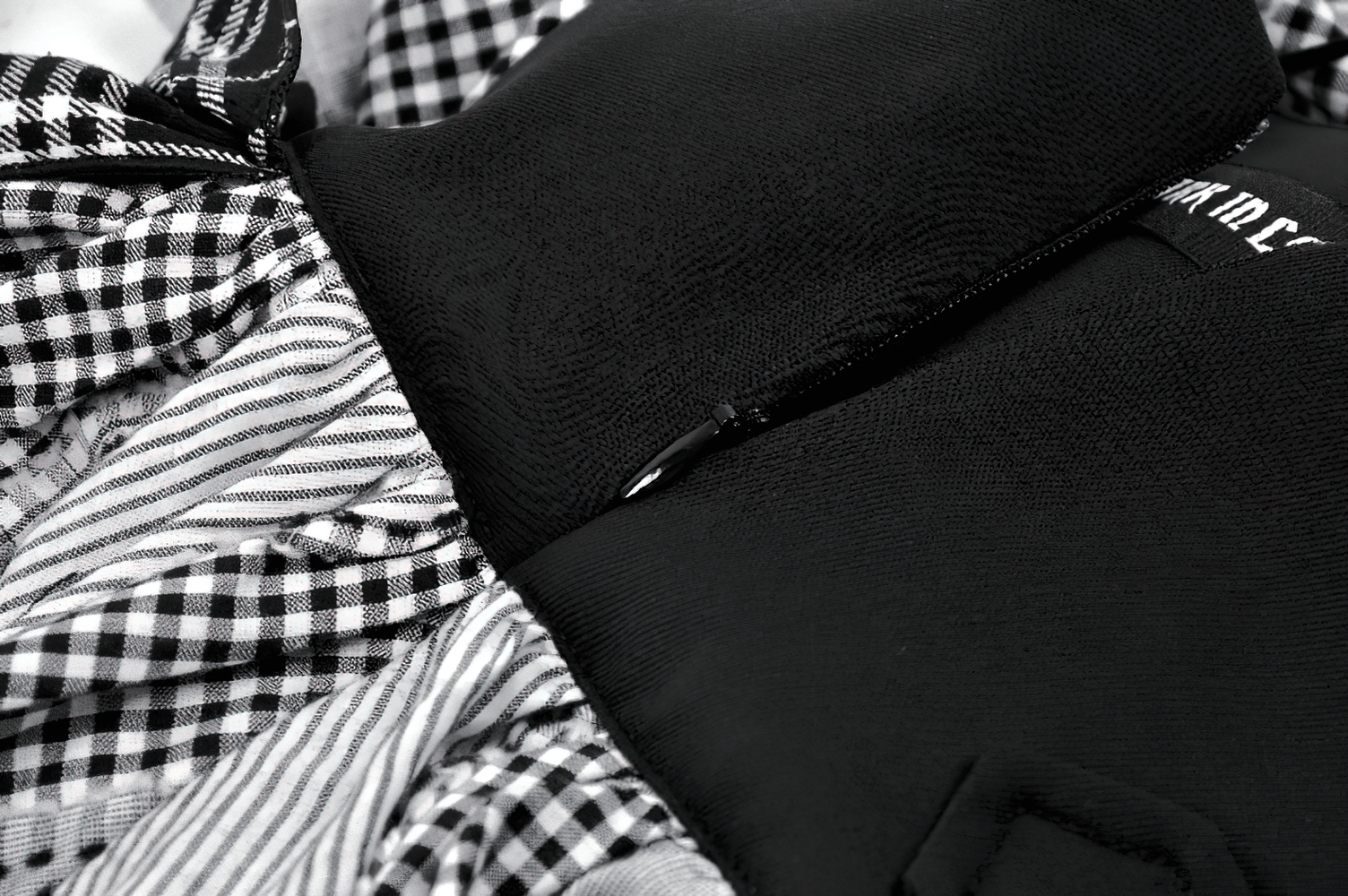 Plaid Skirt with Ruffled Design and Adjustable Belts featuring stylish ruffles and black fabric close-up.