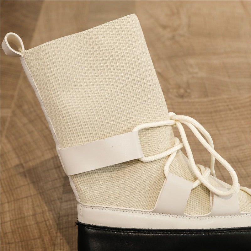 Close-up of platform women's lace-up boots in stretch fabric, showcasing white color and unique design details.