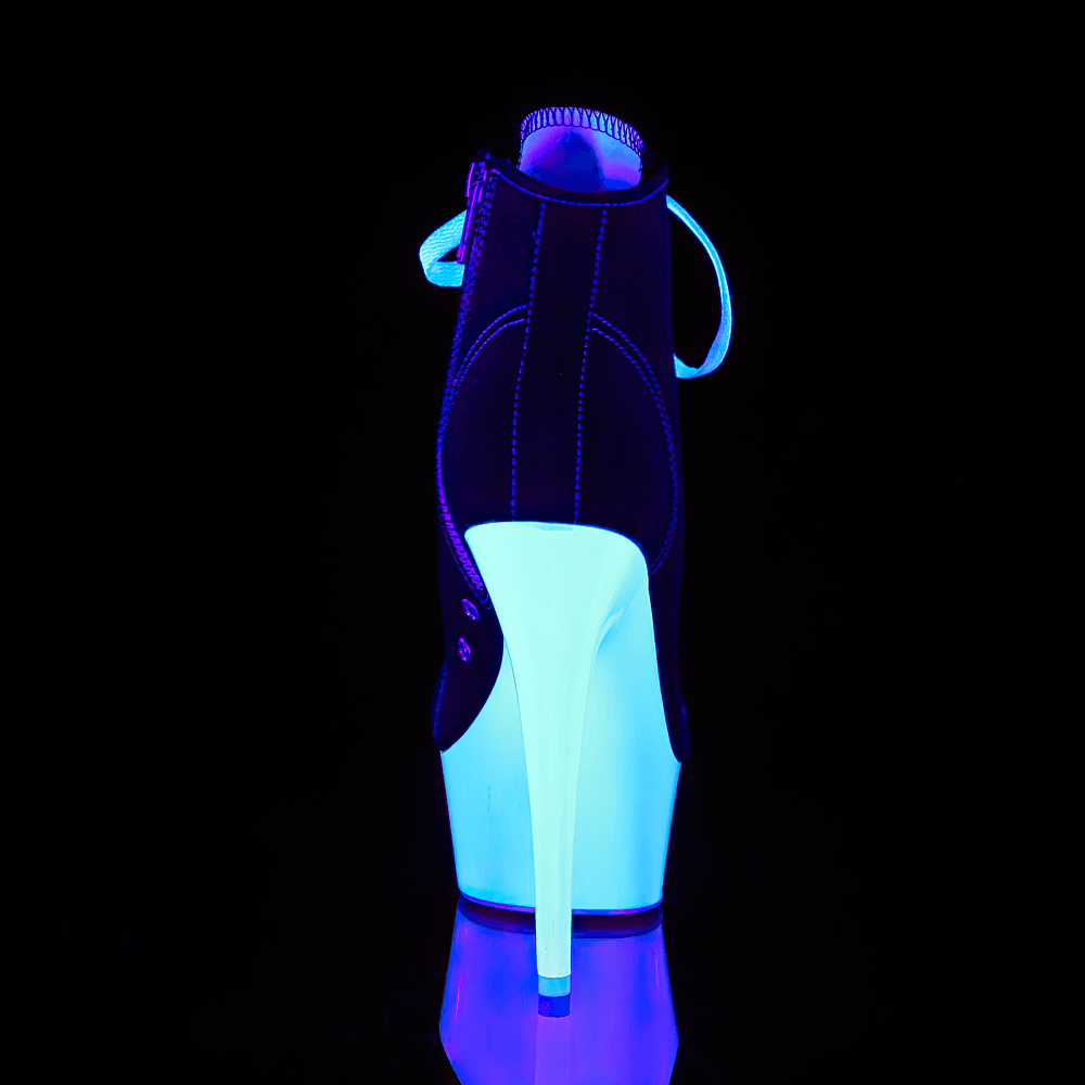 Stylish PLEASER black and white stiletto heels glowing under UV light, showcasing lace-up and zip design.