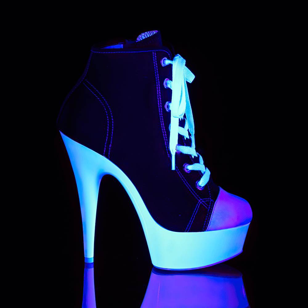 Chic black and white lace-up stiletto heels with a 6-inch heel and bold platform, glowing under blue light.