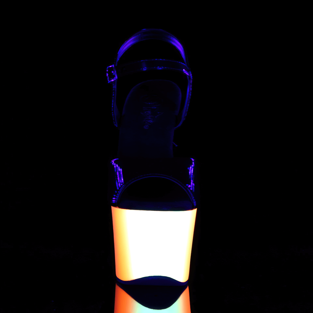 Neon UV reactive platform sandals with 7-inch heels glowing vibrantly under black light.