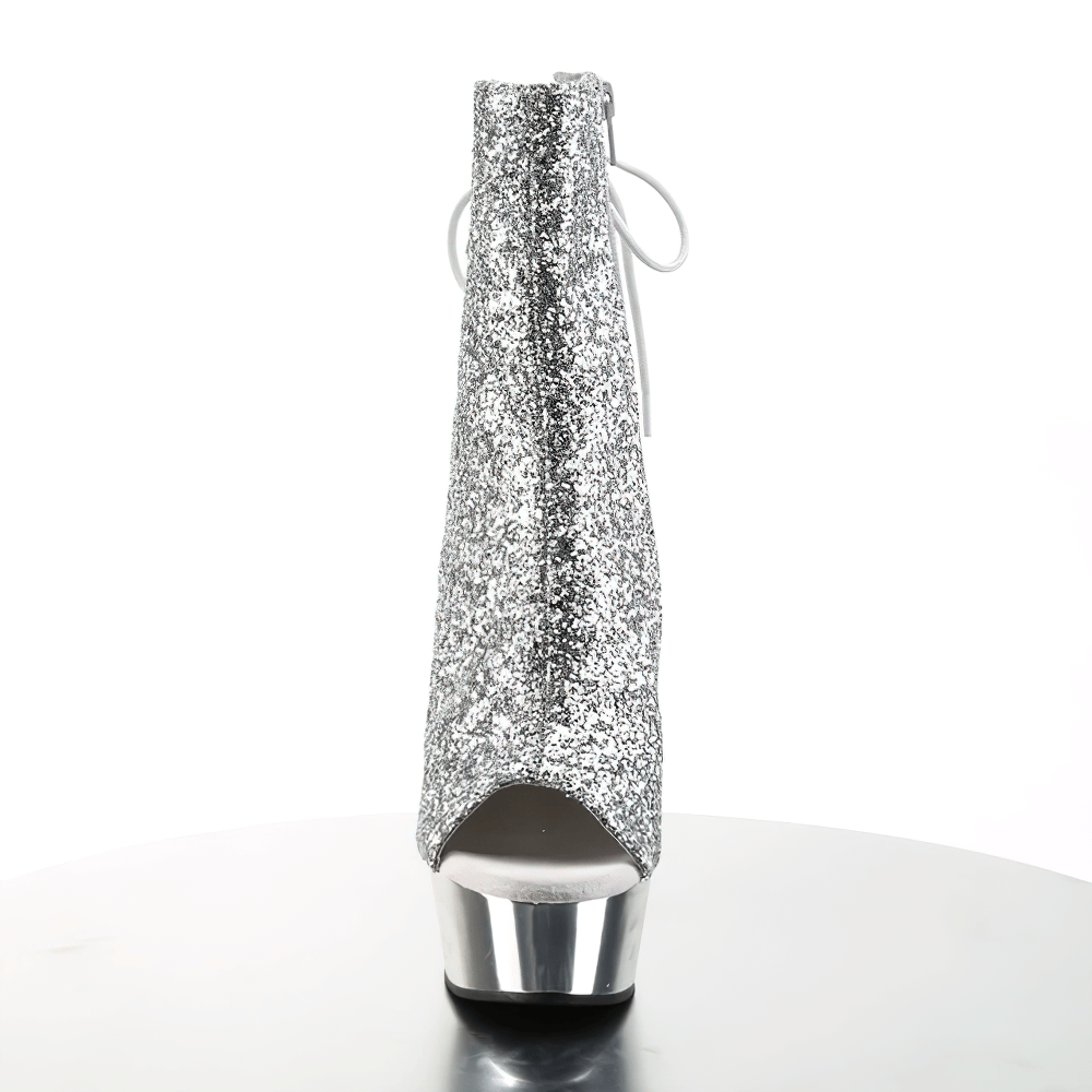 Sparkling silver glitter lace-up stiletto heels ankle boots with open toe and back zip on a display table.