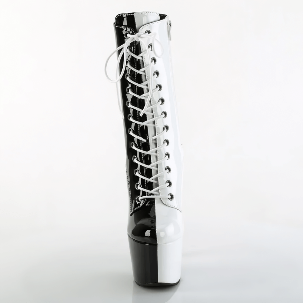 Black and white two-tone lace-up ankle boot with 7-inch heel and platform, perfect for trendy fashion statements.