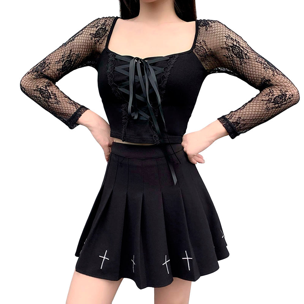Gothic woman wearing a pleated black mini skirt with crosses and a lace-up black top for a stylish rock chick look.