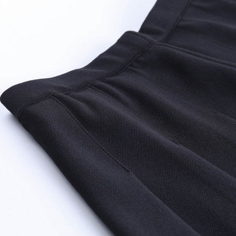 Close-up of a pleated black gothic mini skirt fabric, showcasing texture and stylish design details for alternative outfits.
