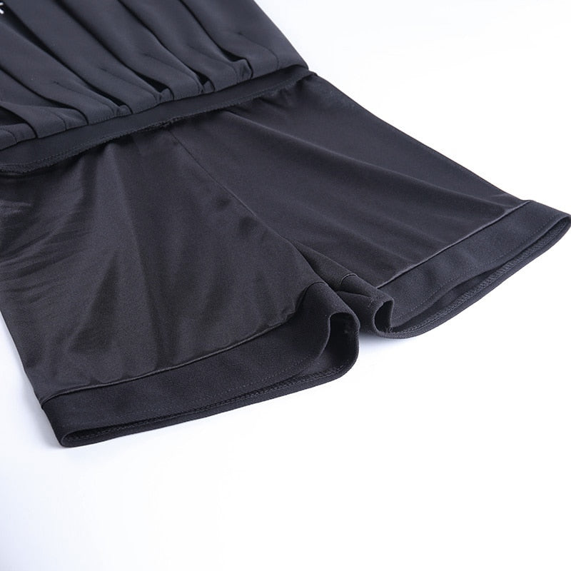 Close-up of black pleated skirt hem, showcasing smooth fabric and stylish design for gothic rock chick outfits.