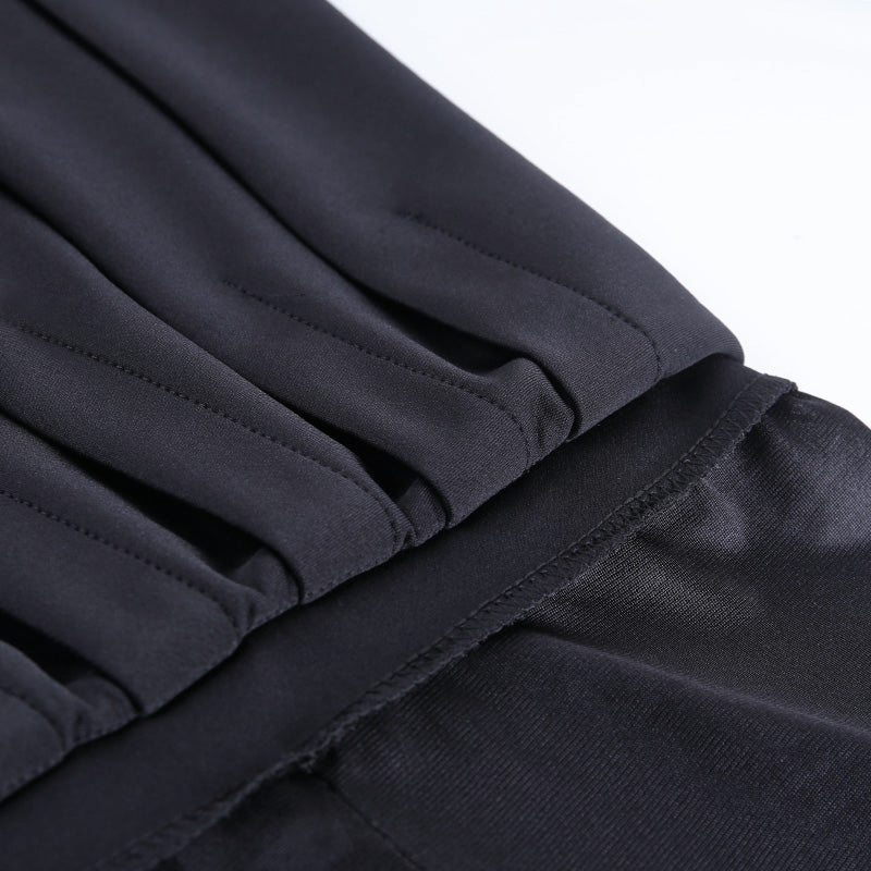 Close-up of pleated black gothic mini skirt with stylish details, perfect for alternative outfits and Halloween parties.
