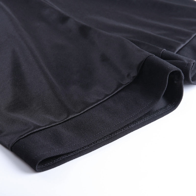 Close-up of a black pleated mini skirt's hem, showcasing the smooth fabric and sleek design for gothic fashion.