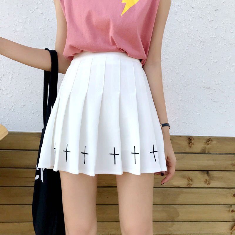 Pleated white mini skirt with black crosses at the hem, perfect for gothic or rock chick style.