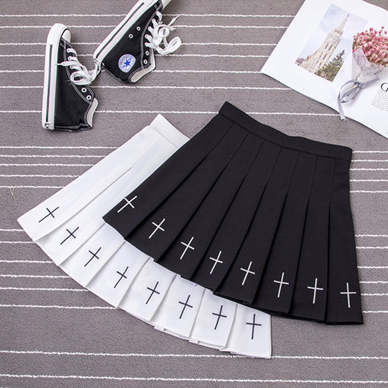 Pleated gothic mini skirts in black and white with cross details, perfect for rock chick outfits and Halloween parties.