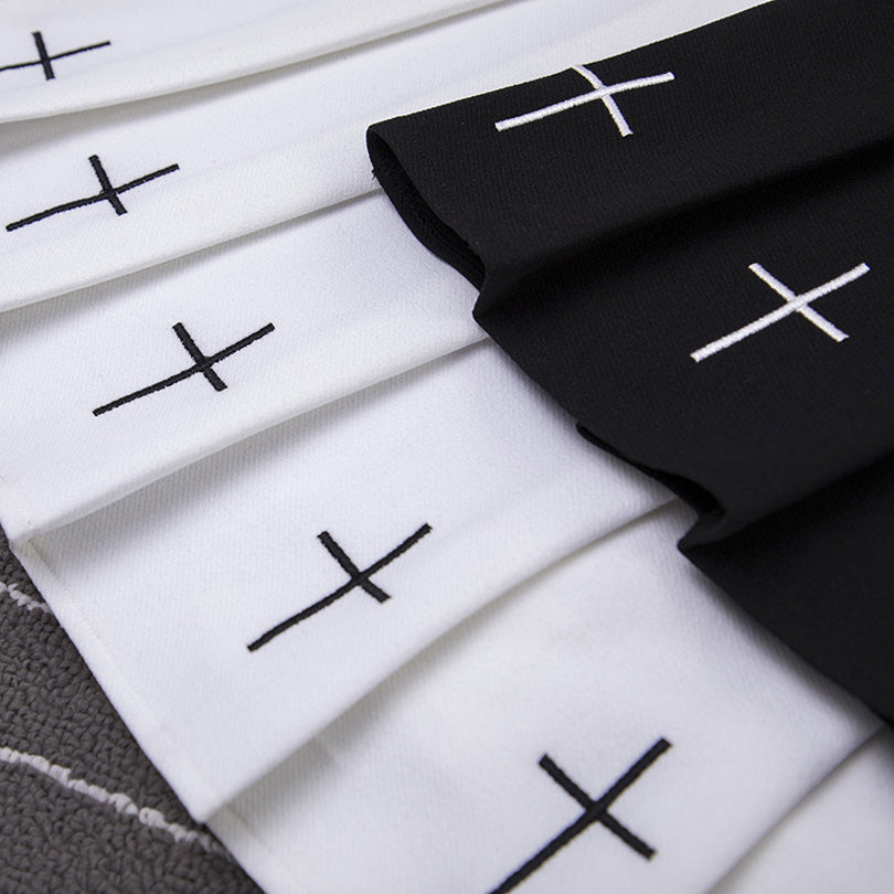 Pleated gothic women skirts featuring black and white fabric with cross patterns, perfect for rock chick outfits.