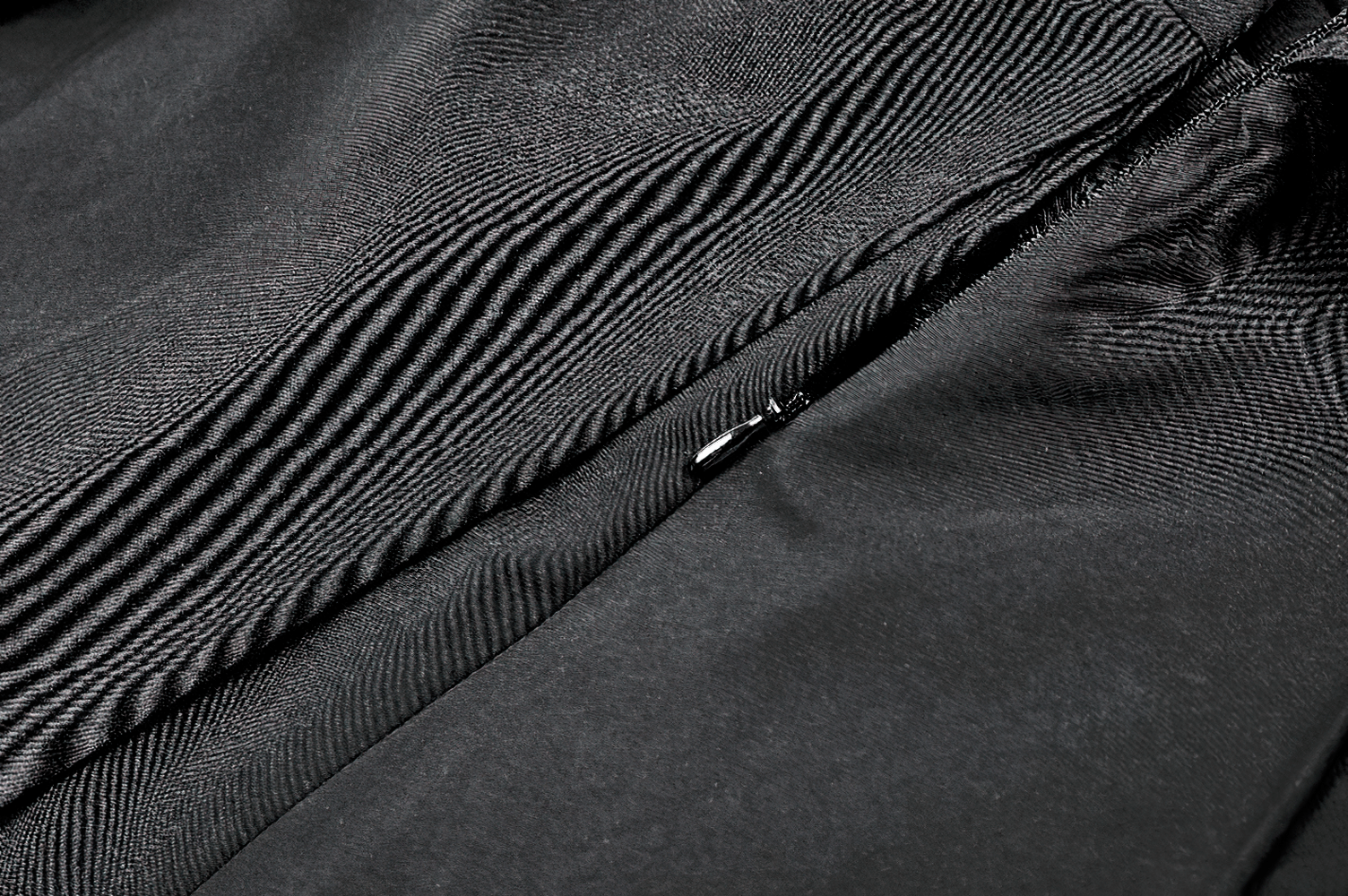 Pleated Mini Dress with Corset Lace-Up Back Detail in black, featuring a textured close-up of the corset back and fabric