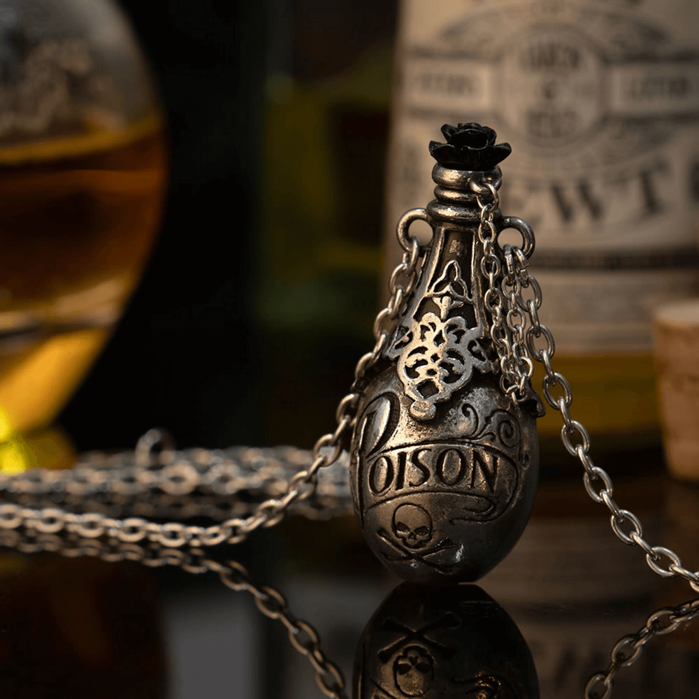 Vintage poison bottle pendant necklace with skull and black rose detail, evoking dark elegance and mystery.