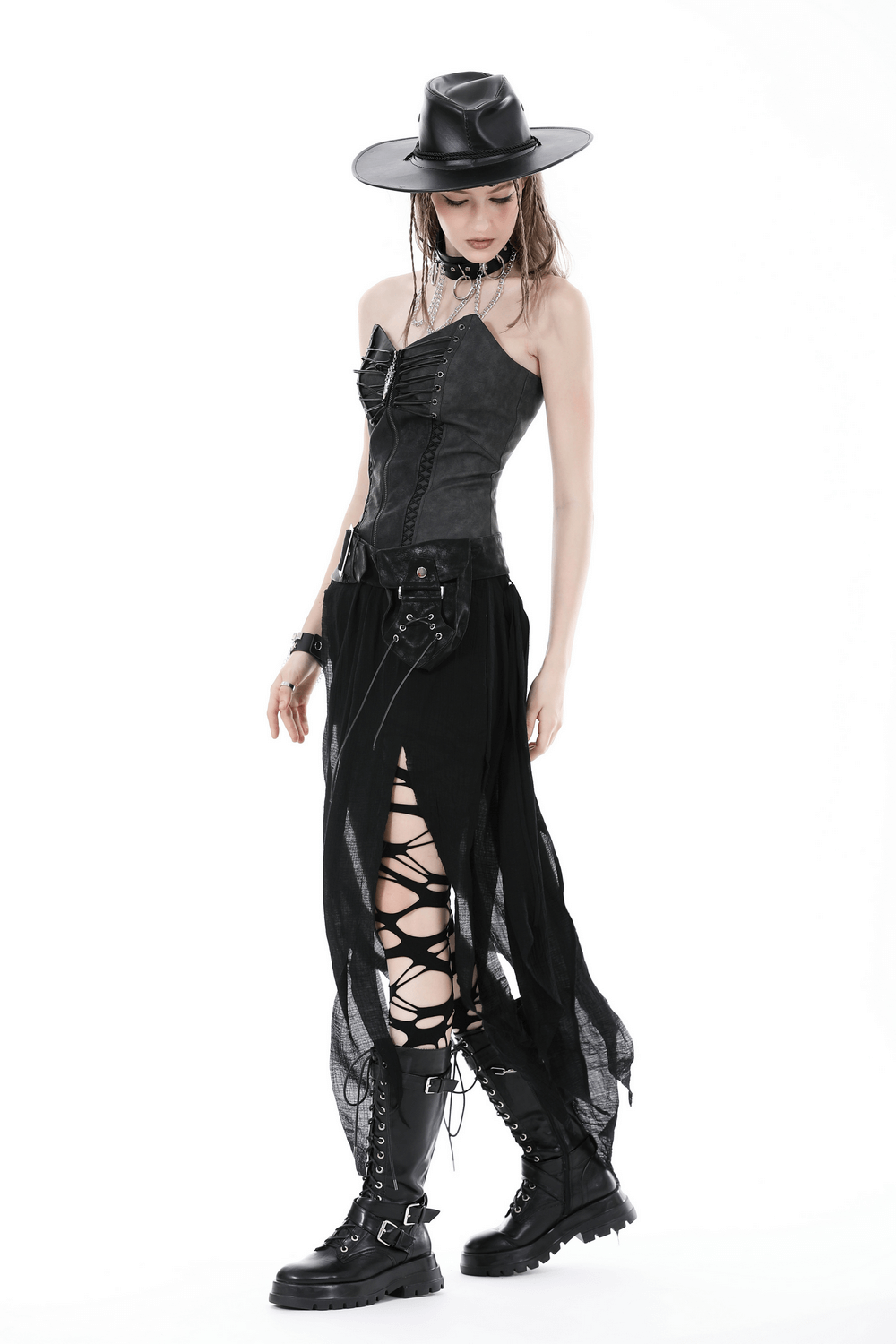 Woman in punk-style outfit with lace-up skirt and black belt, showcasing edgy goth fashion.