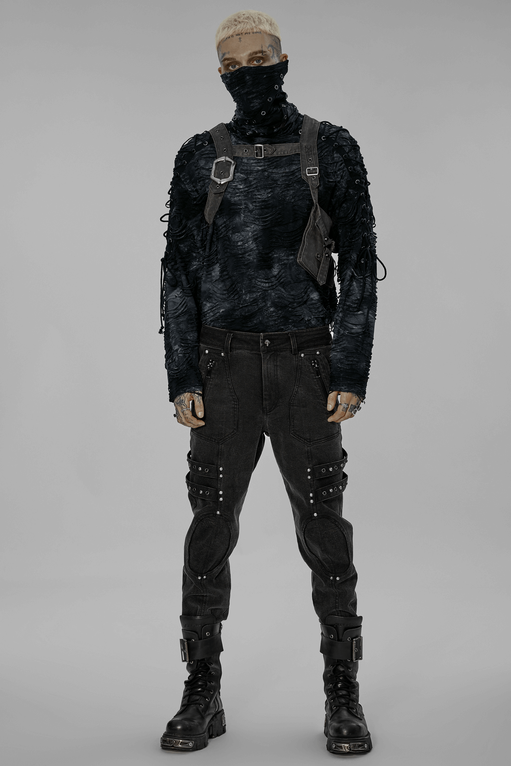 Model wearing post-apocalyptic punk outfit with leather and stylish accessories for a bold goth aesthetic.